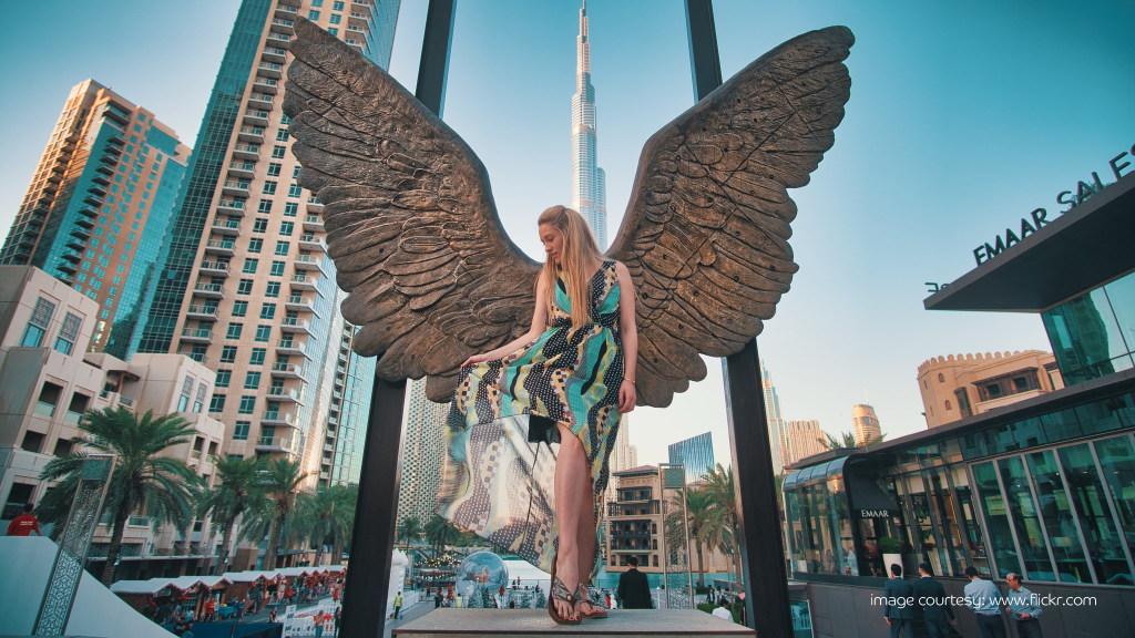 Girl posing by Wings of Mexico statue, one of Dubai’s most Instagrammable places.