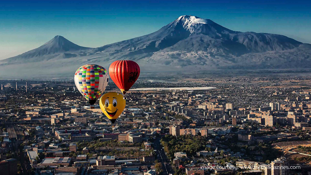 Hot air balloons over Armenia’s landscape, cheap travel destination.