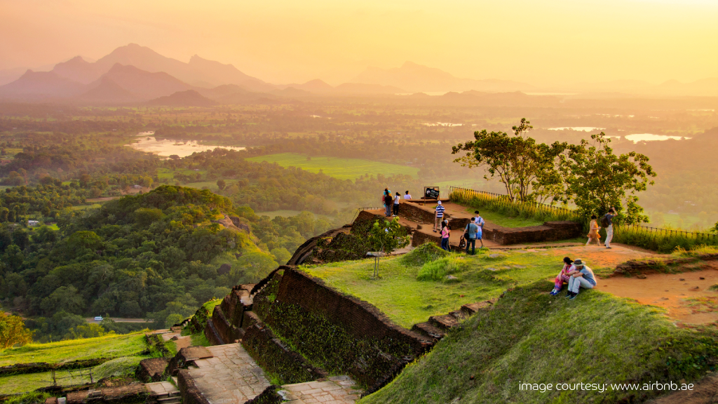 Travelers enjoying sunset views in lush Sri Lanka, cheap travel destination.